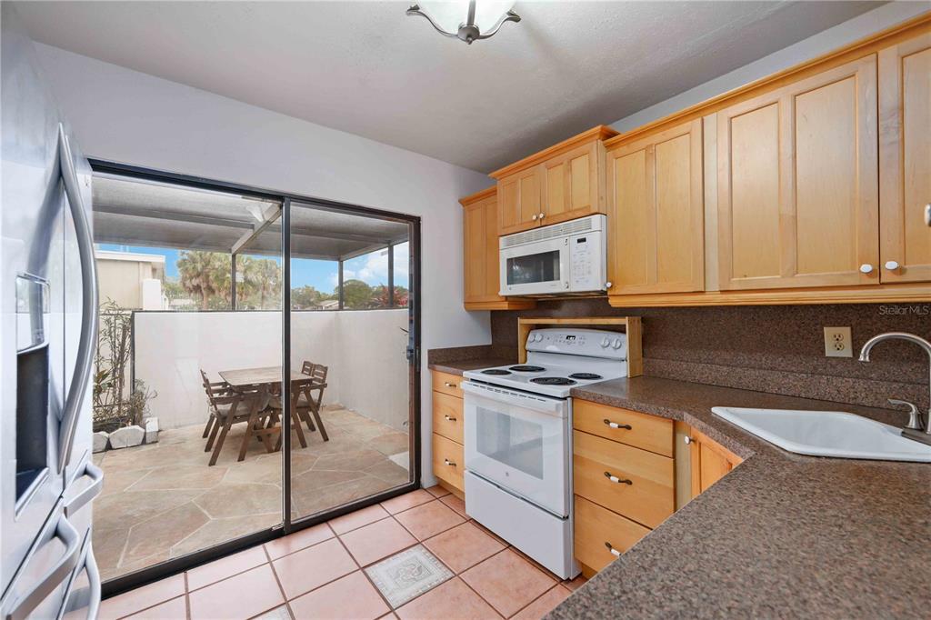 2767 Horseshoe Court, Unit Q3 Sarasota, FL 34235 - Photo 19 of 49 a kitchen with stainless steel appliances granite countertop a stove top oven a sink and a granite counter top