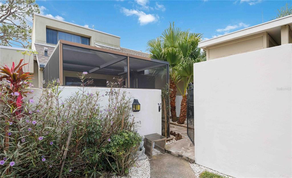 2767 Horseshoe Court, Unit Q3 Sarasota, FL 34235 - Photo 2 of 49 a view of a house with a tree