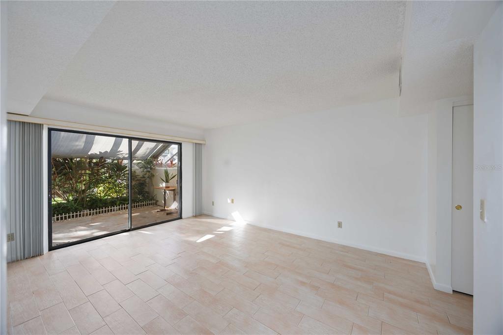 2767 Horseshoe Court, Unit Q3 Sarasota, FL 34235 - Photo 21 of 49 an empty room with wooden floor and windows