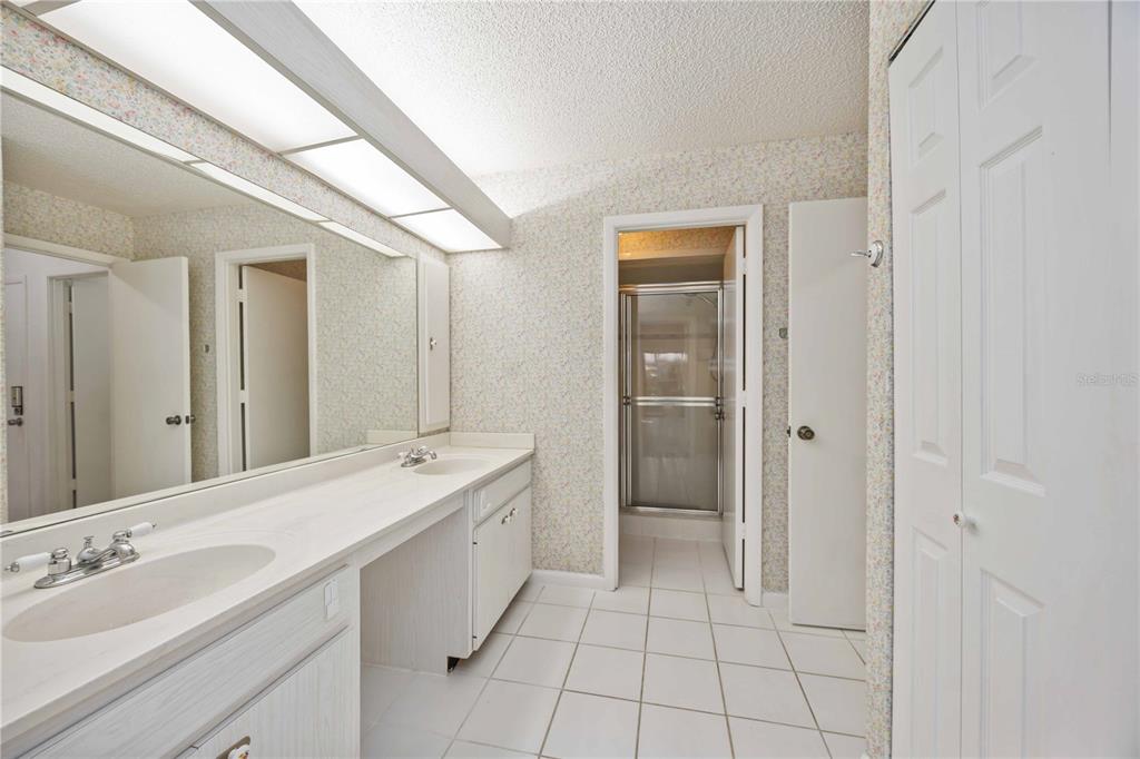 2767 Horseshoe Court, Unit Q3 Sarasota, FL 34235 - Photo 23 of 49 a spacious bathroom with a shower and a sink