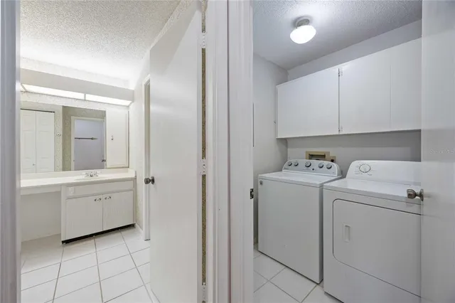 a view of utility room with closet and dryer