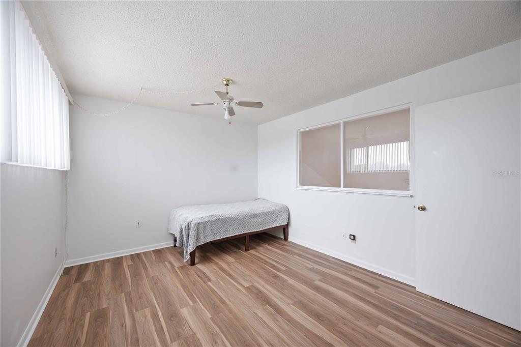 2767 Horseshoe Court, Unit Q3 Sarasota, FL 34235 - Photo 29 of 49 a room with a bed and wooden floor