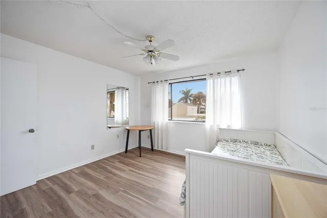 a view of a room with a window and wooden floor