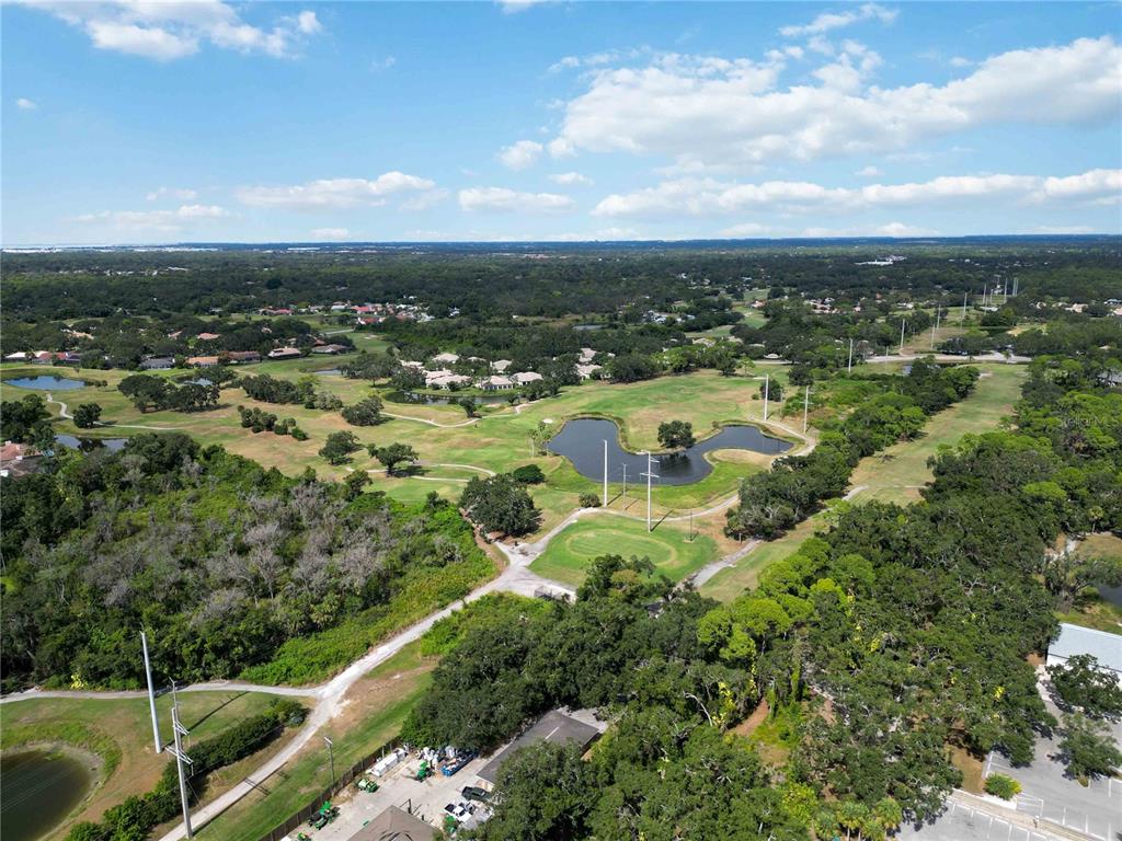 2767 Horseshoe Court, Unit Q3 Sarasota, FL 34235 - Photo 47 of 49 an aerial view of residential houses with outdoor space and trees