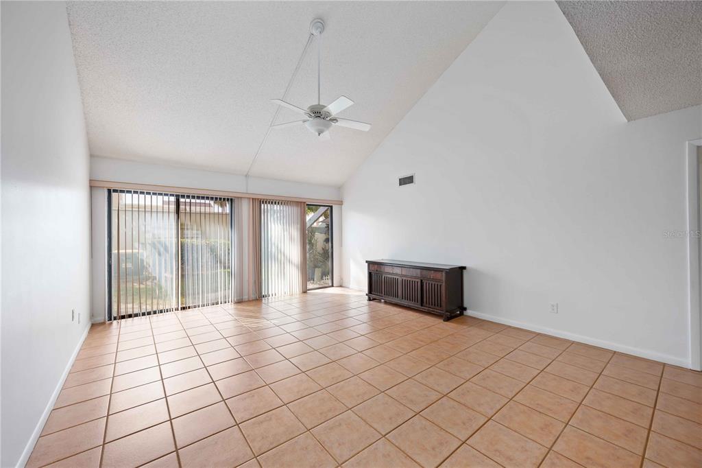 2767 Horseshoe Court, Unit Q3 Sarasota, FL 34235 - Photo 9 of 49 a room with a bed and a large window