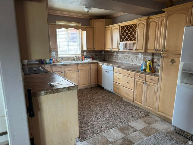 1124 Washam Road Green River, WY 82938 - Photo 19 of 35 Kitchen featuring light wood-finish cabinetry, a patterned tile backsplash, and a built-in wine rack