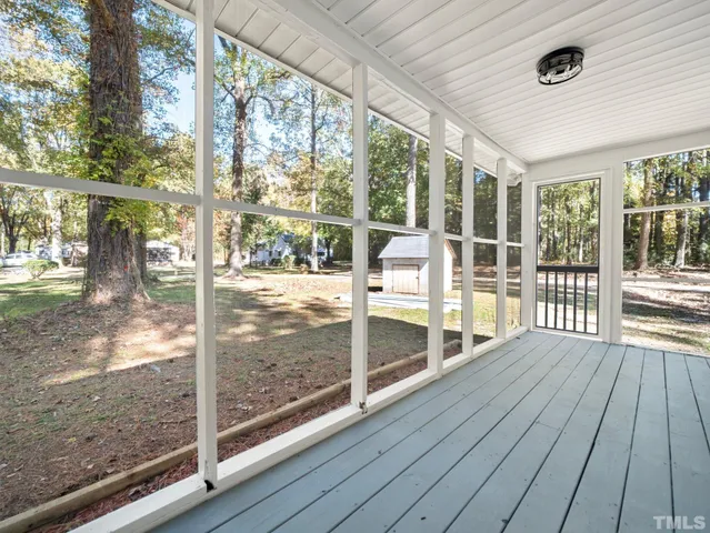 a view of porch with wooden floor