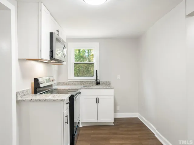 a kitchen with stainless steel appliances granite countertop a sink stove and a granite counter top