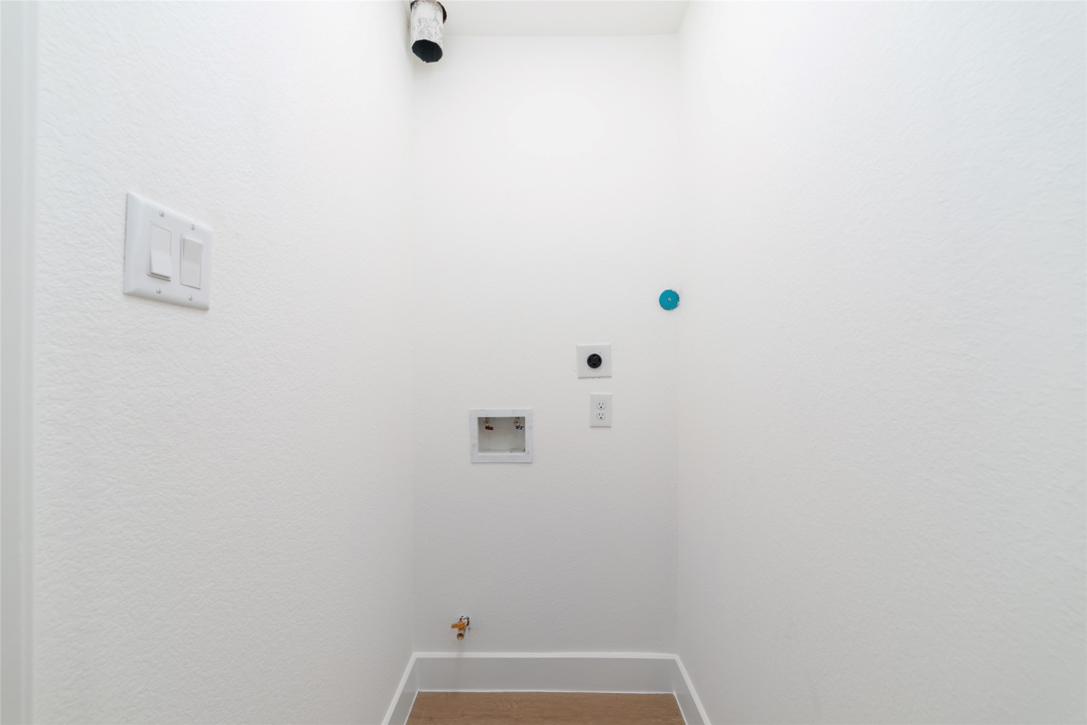 5709 Langley Road Houston, TX 77016 - Photo 23 of 27 This is a small, white utility space with plumbing and electrical connections, ideal for installing a washer and dryer.