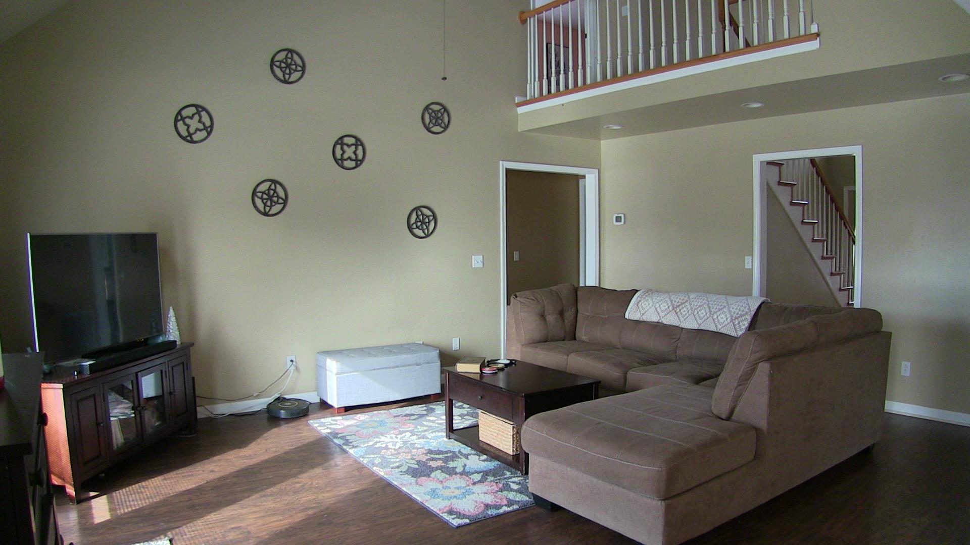 187 Coleman Road Readyville, TN 37149 - Photo 3 of 30 The living room has a vaulted ceiling with a drop down ceiling fan along with an exterior door leading to the back patio