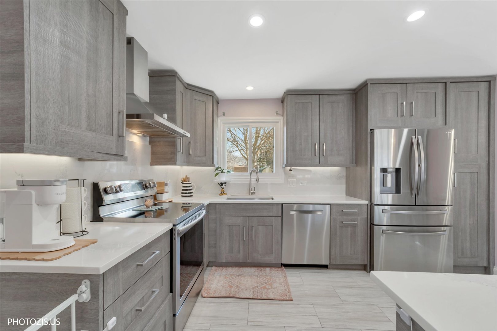 981 North Mill Road Addison, IL 60101 - Photo 12 of 41 a kitchen with a sink stainless steel appliances and cabinets