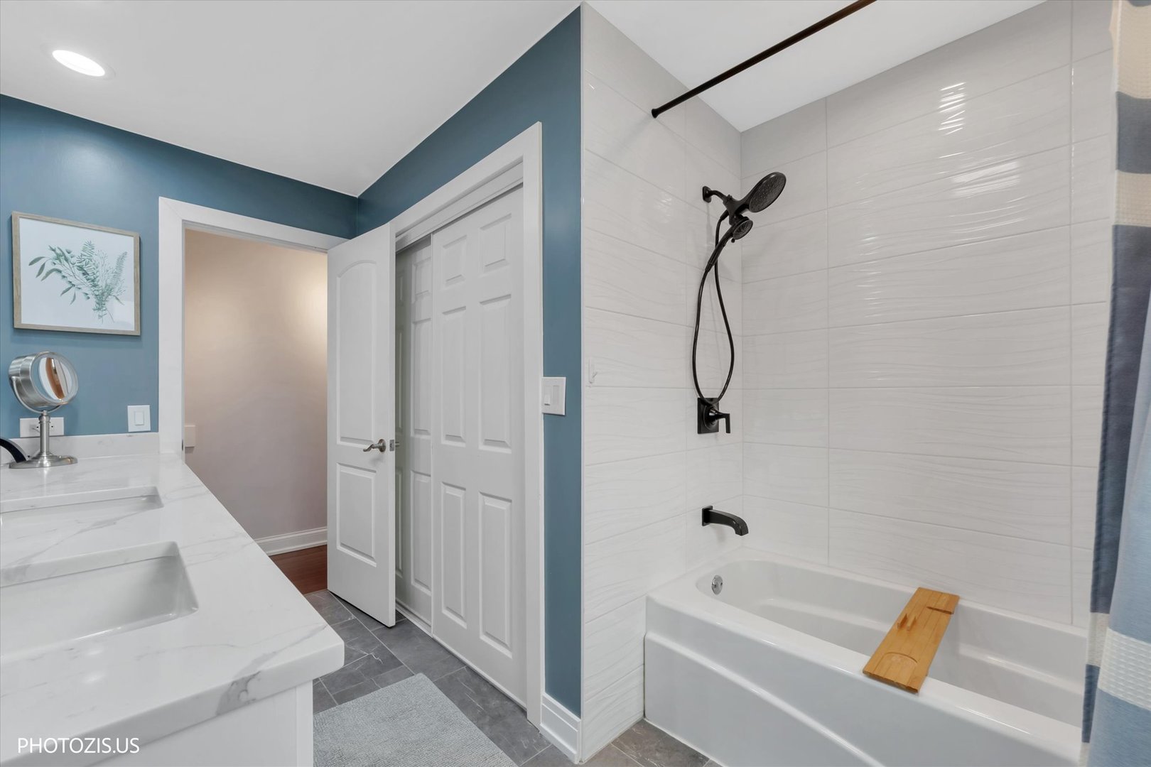 981 North Mill Road Addison, IL 60101 - Photo 17 of 41 a bathroom with a tub shower vanity and a sink