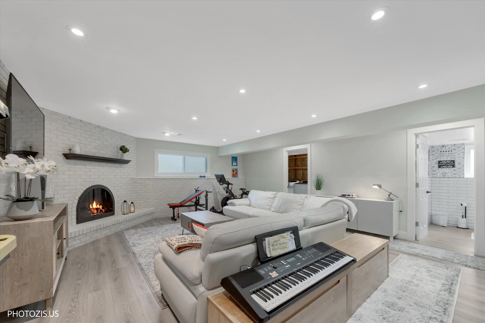981 North Mill Road Addison, IL 60101 - Photo 28 of 41 a living room with furniture a fireplace and a flat screen tv