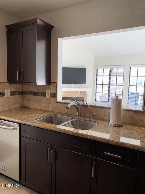407 Shoreview Drive Port Hueneme, CA 93041 - Photo 9 of 39 a kitchen with granite countertop a sink and a wooden cabinets