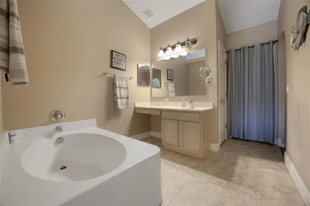 a spacious bathroom with a bathtub and a sink
