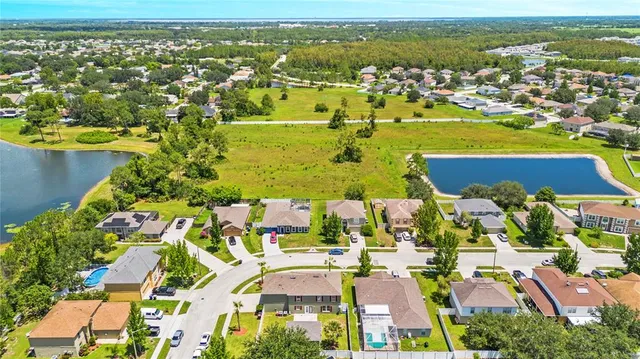 an aerial view of residential houses with outdoor space