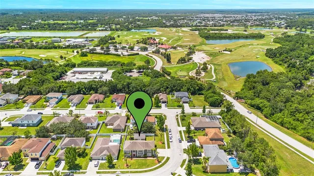 an aerial view of residential houses with outdoor space and swimming pool