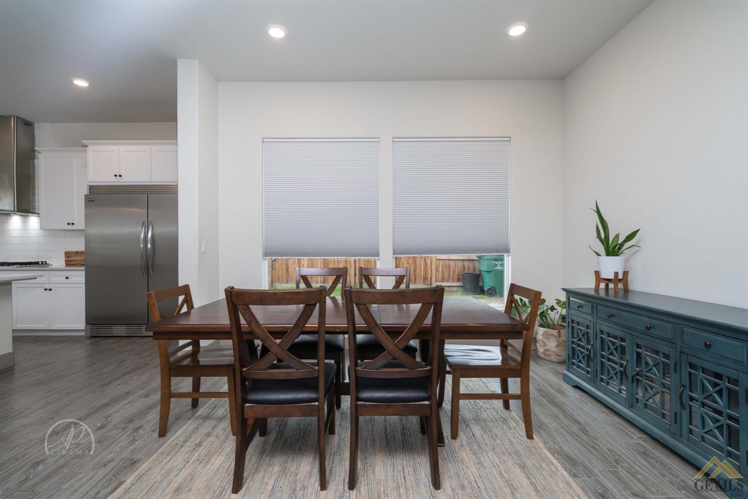 Undisclosed Address Shafter, CA 93263 - Photo 14 of 30 a view of a dining room with furniture and wooden floor