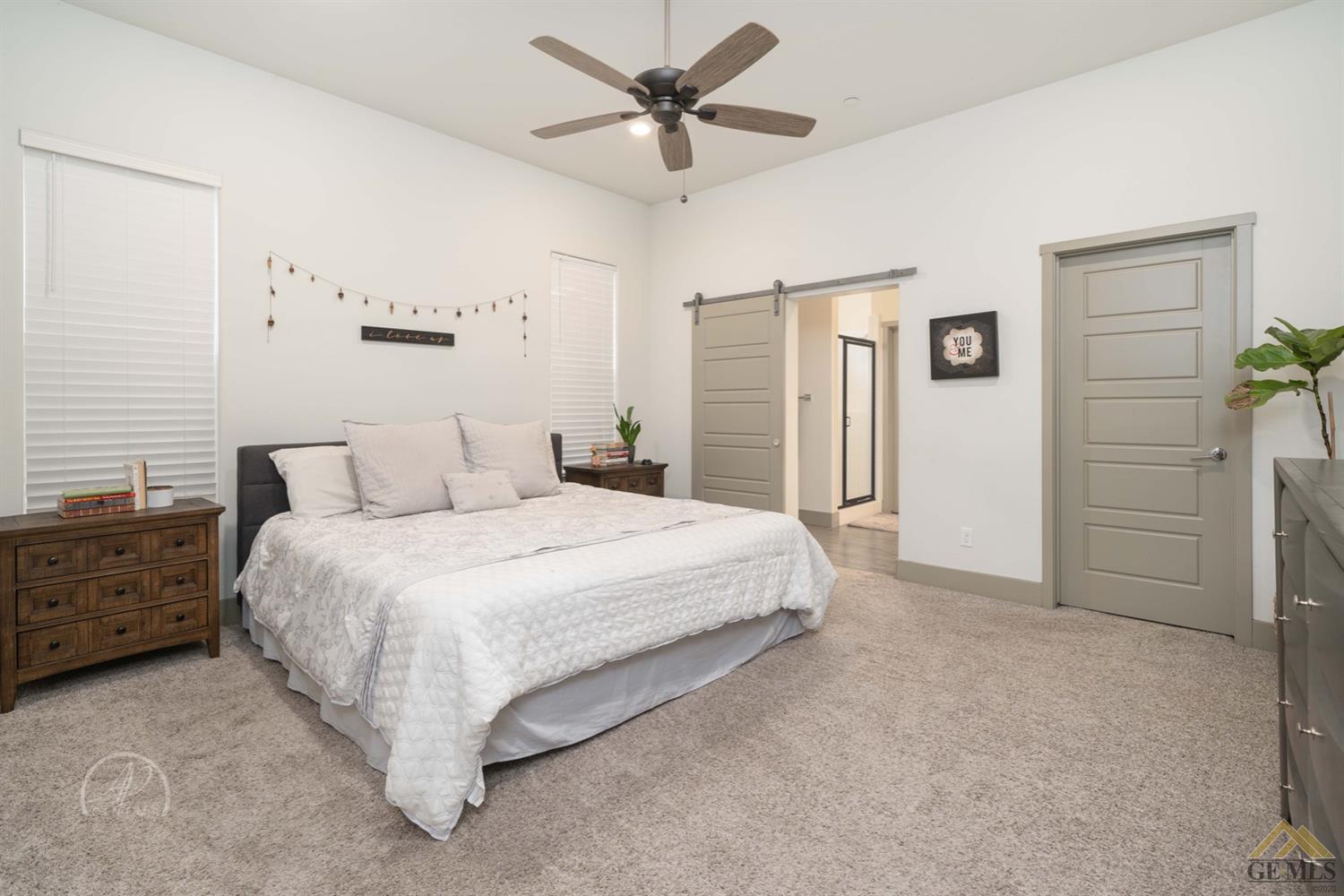 Undisclosed Address Shafter, CA 93263 - Photo 17 of 30 a spacious bedroom with a bed and a chandelier