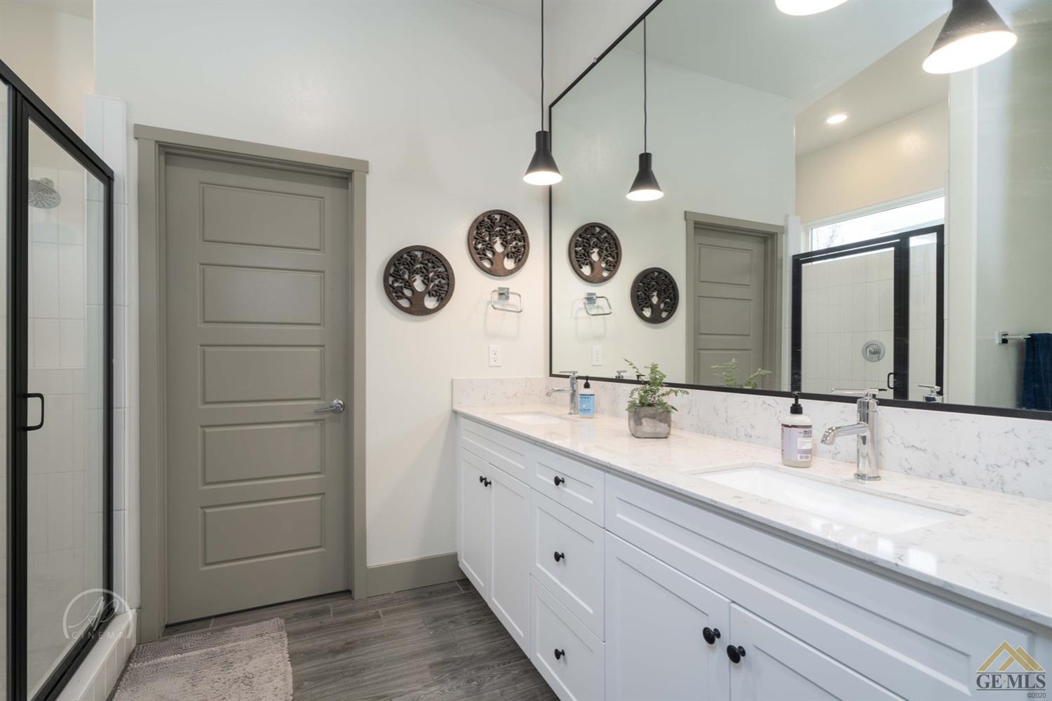 Undisclosed Address Shafter, CA 93263 - Photo 19 of 30 a bathroom with a double vanity sink and a mirror