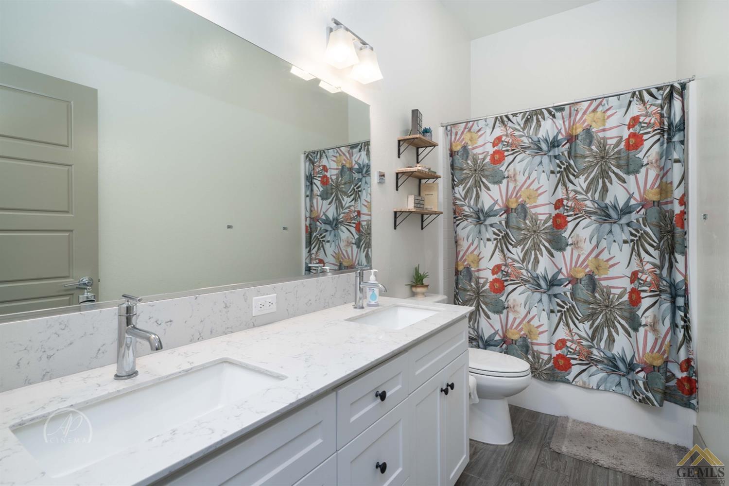 Undisclosed Address Shafter, CA 93263 - Photo 23 of 30 a bathroom with a sink a toilet and shower curtain