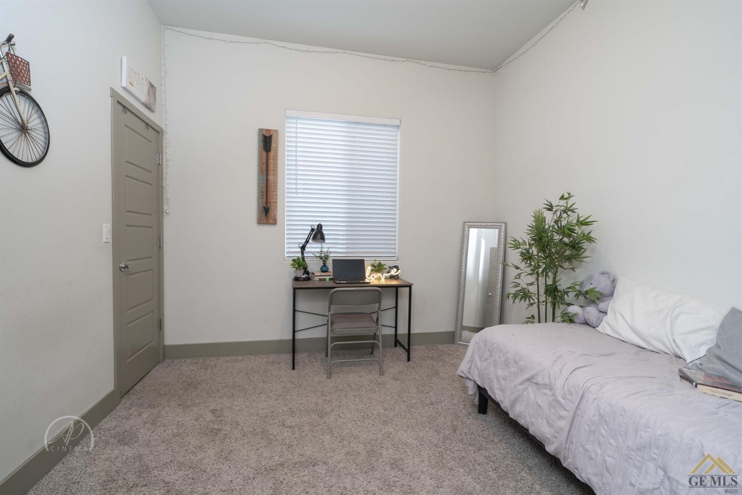 Undisclosed Address Shafter, CA 93263 - Photo 24 of 30 a bedroom with a bed and a table