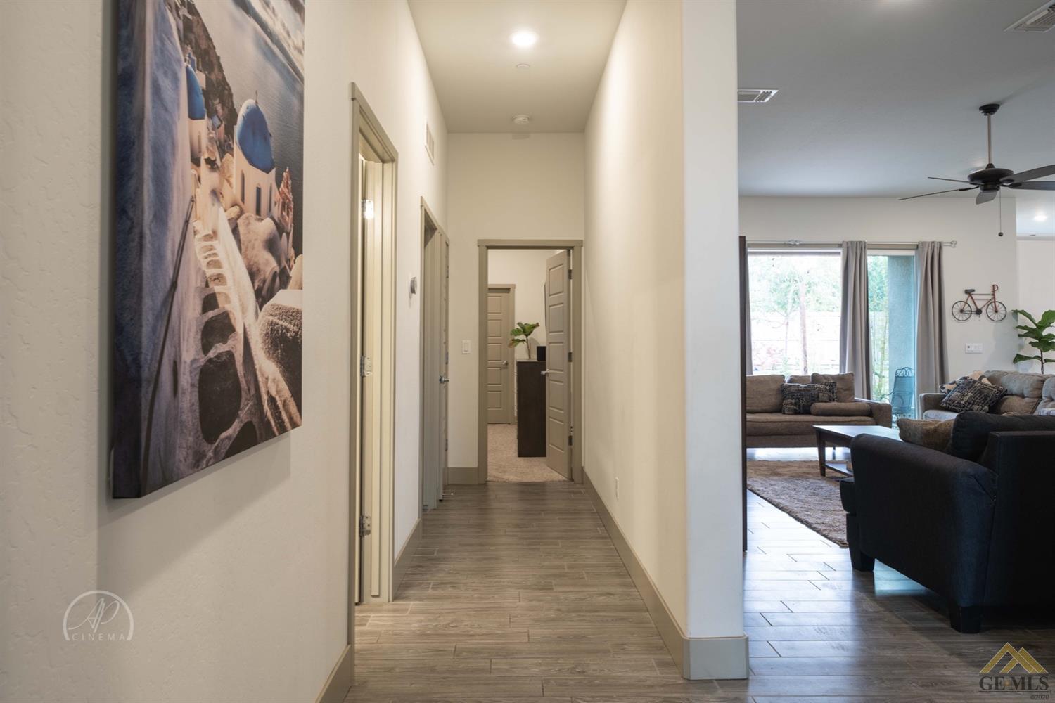 Undisclosed Address Shafter, CA 93263 - Photo 27 of 30 a view of a hallway with furniture and wooden floor