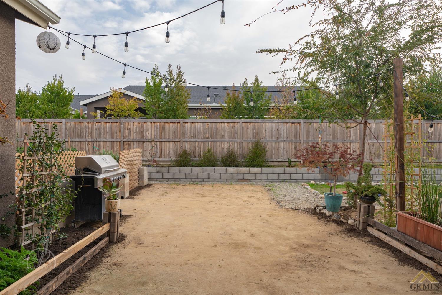 Undisclosed Address Shafter, CA 93263 - Photo 28 of 30 a view of a backyard with plants and outdoor seating