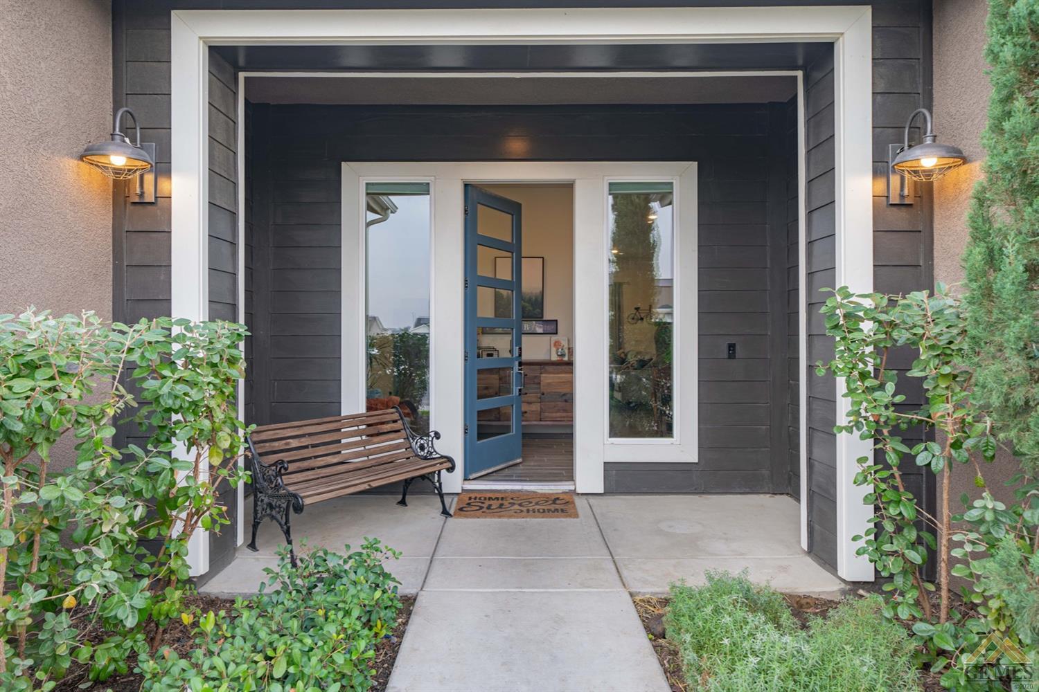 Undisclosed Address Shafter, CA 93263 - Photo 4 of 30 a view of brick house with potted plants and a bench