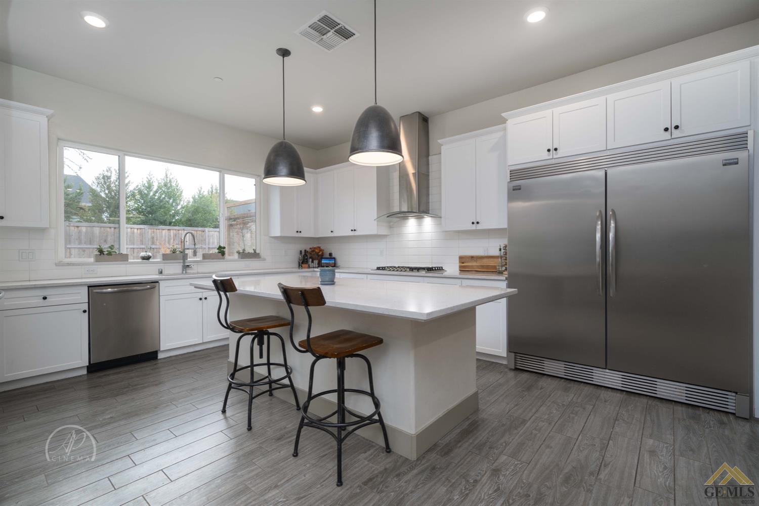 Undisclosed Address Shafter, CA 93263 - Photo 5 of 30 a kitchen with kitchen island granite countertop a sink a center island and a window