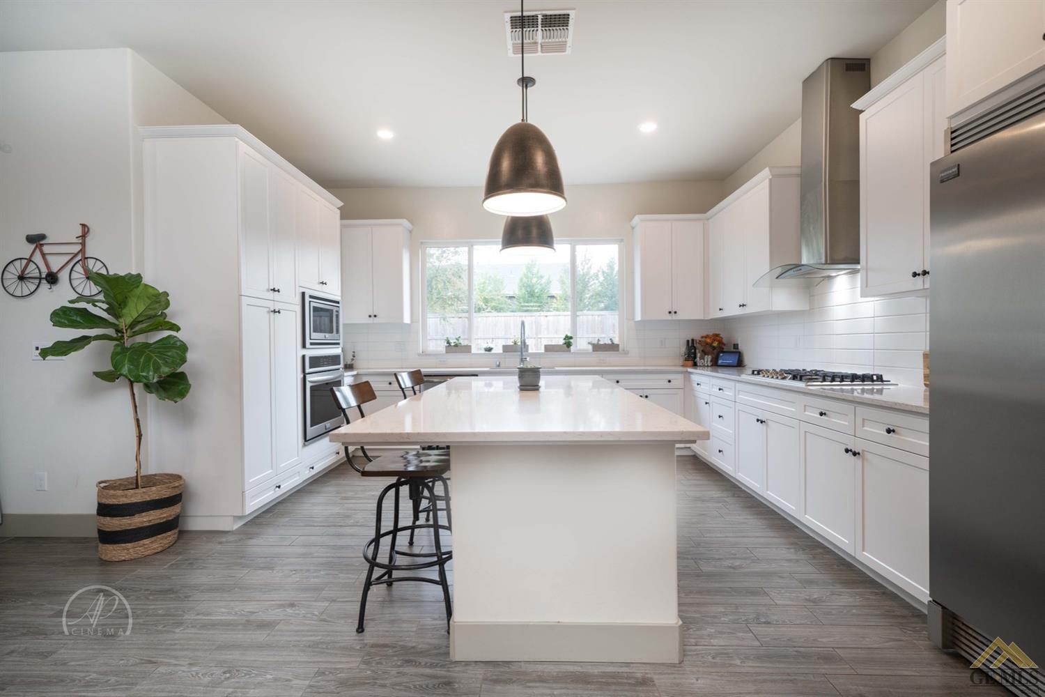 Undisclosed Address Shafter, CA 93263 - Photo 7 of 30 a kitchen with kitchen island a counter top space appliances and cabinets
