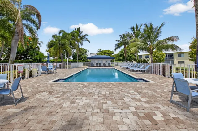 a view of a house with swimming pool and sitting area