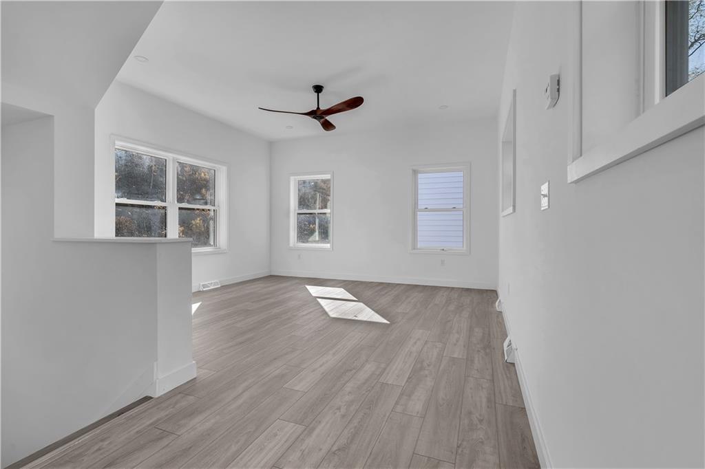 431 Shaler Street Pittsburgh, PA 15211 - Photo 2 of 33 a view of empty room with wooden floor and fan
