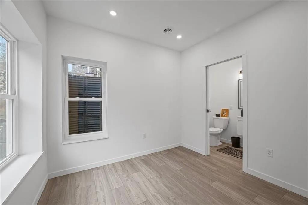 431 Shaler Street Pittsburgh, PA 15211 - Photo 27 of 33 a view of empty room with wooden floor and fan