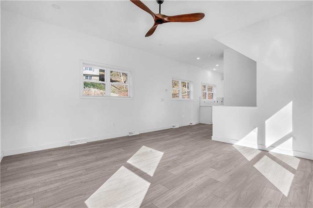 431 Shaler Street Pittsburgh, PA 15211 - Photo 3 of 33 a view of a livingroom with wooden floor and a ceiling fan