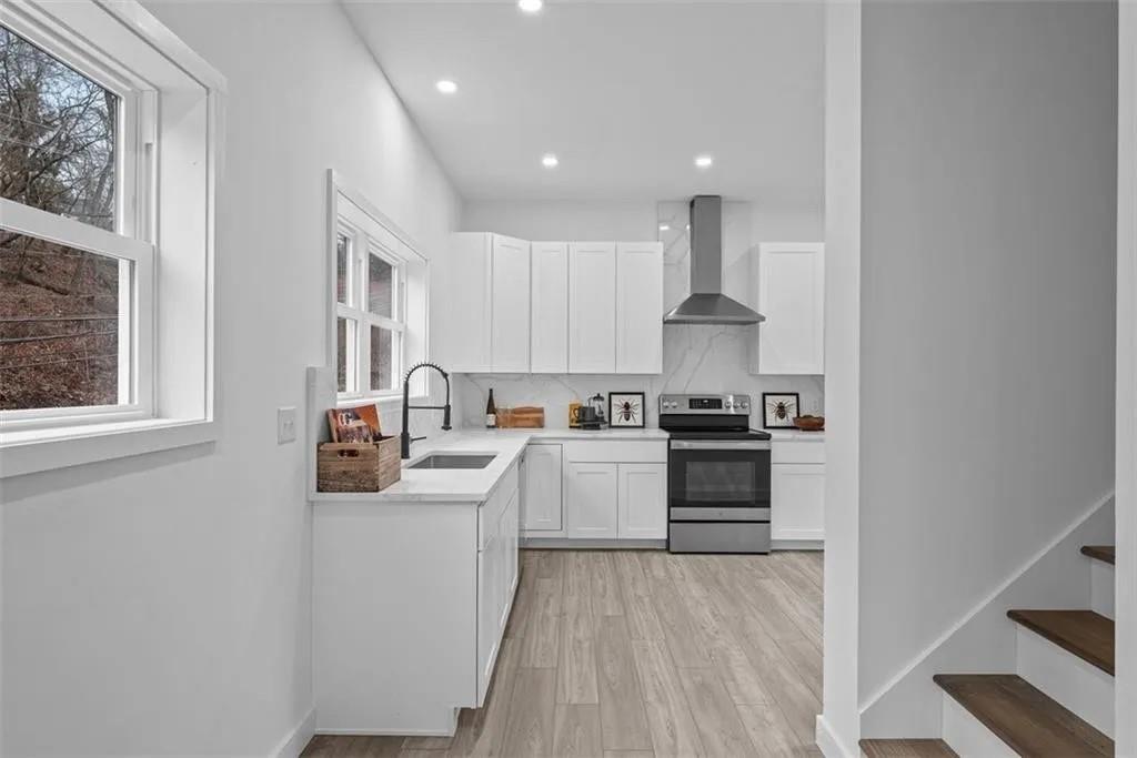 431 Shaler Street Pittsburgh, PA 15211 - Photo 5 of 33 a kitchen with stainless steel appliances granite countertop a stove and a sink