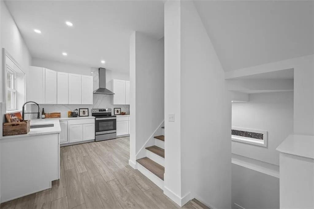431 Shaler Street Pittsburgh, PA 15211 - Photo 6 of 33 a kitchen with granite countertop white cabinets and stainless steel appliances