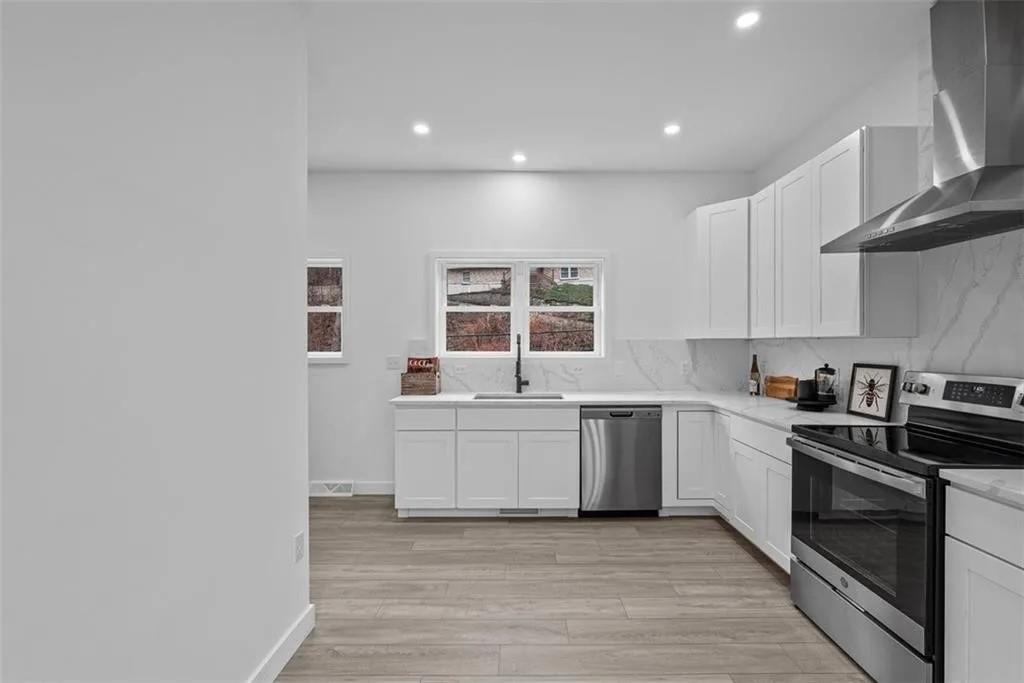 431 Shaler Street Pittsburgh, PA 15211 - Photo 8 of 33 a large kitchen with stainless steel appliances granite countertop a stove and a sink