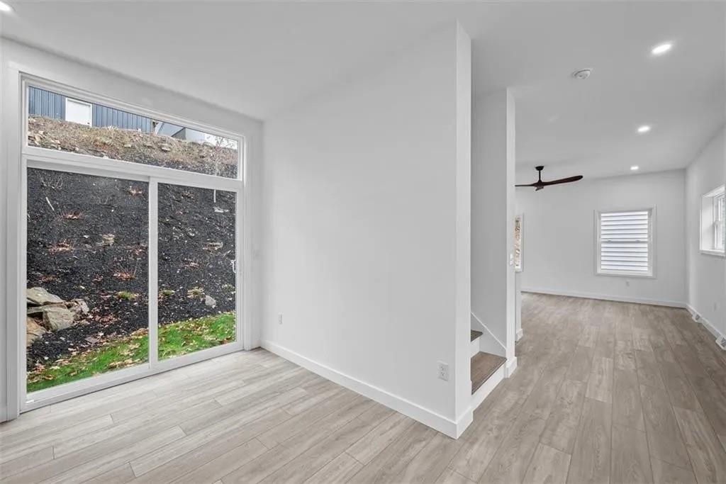 431 Shaler Street Pittsburgh, PA 15211 - Photo 10 of 33 wooden floor in an empty room with a window