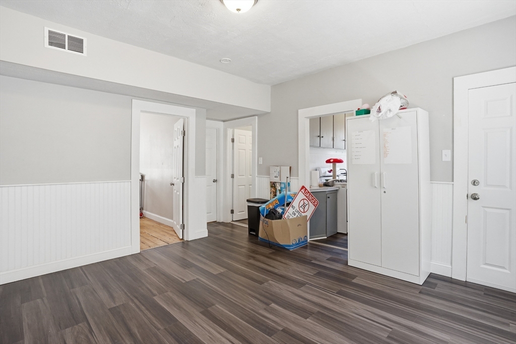 196 Irving Street Fall River, MA 02723 - Photo 5 of 34 a room with wooden floor and white walls