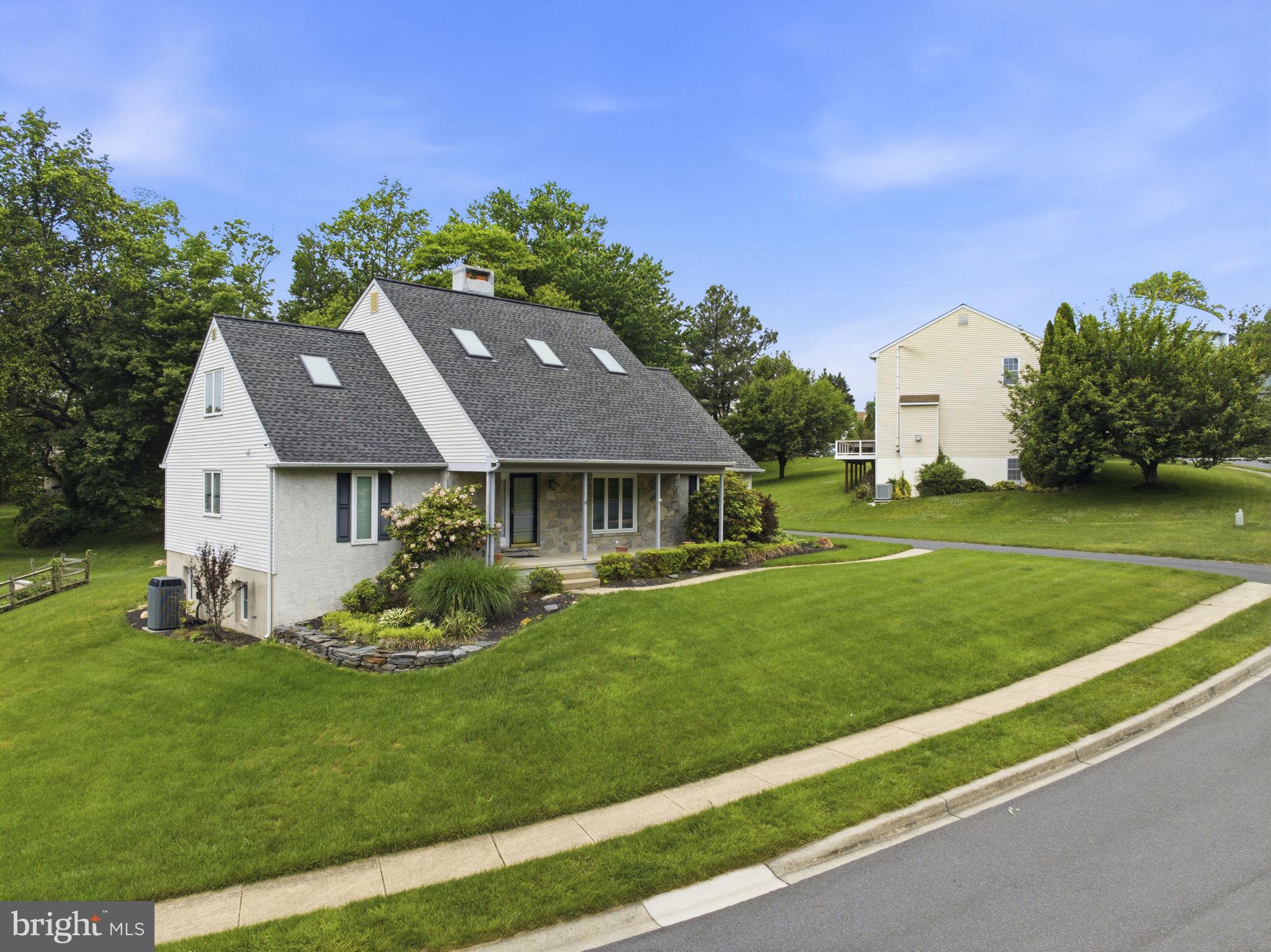 736 Letitia Drive Hockessin, DE 19707 - Photo 81 of 92 a view of a house with a big yard potted plants and a large tree