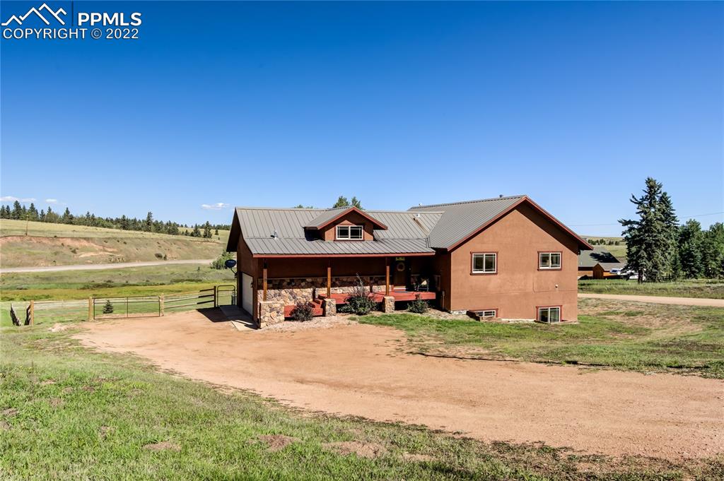 a view of a house with outdoor space and sitting area