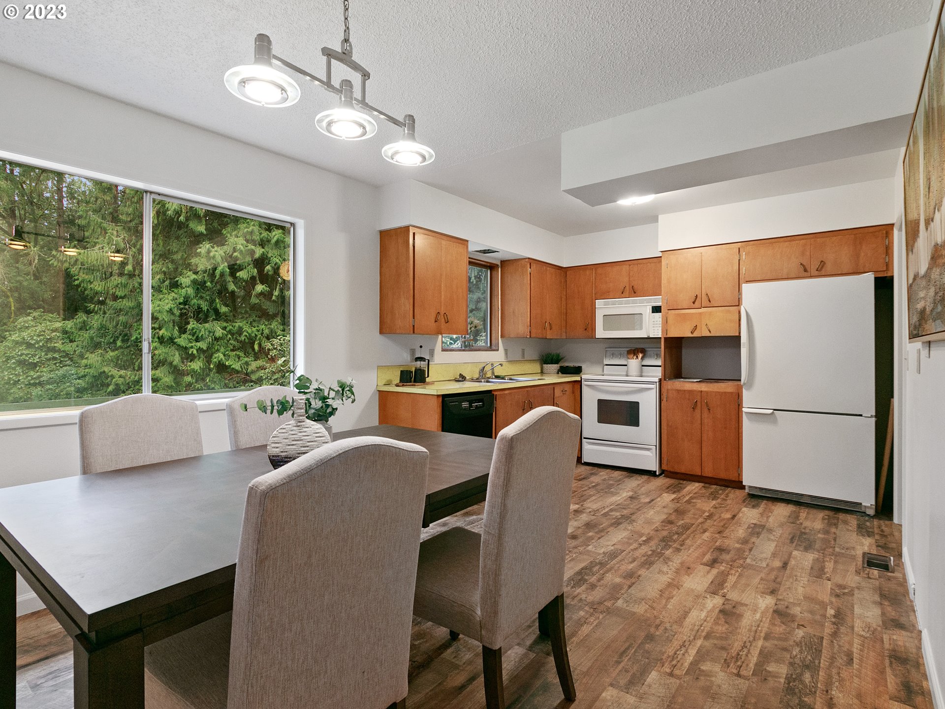 14113 South Graves Road Mulino, OR 97042 - Photo 10 of 33 a open kitchen with stainless steel appliances granite countertop a stove a refrigerator a kitchen island a stove and a dining table with kitchen view