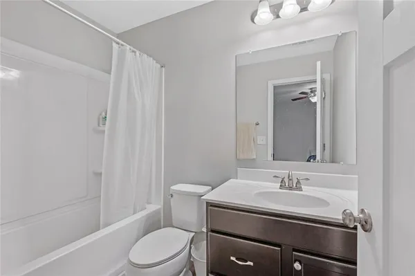 a bedroom with a bed a couch and a chandelier