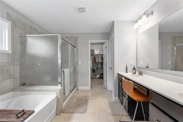 a bathroom with a tub and a shower