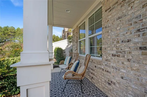 a view of a chair and table in the backyard of a house