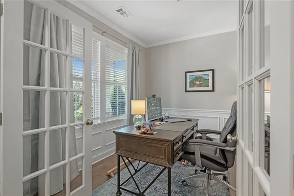 a kitchen with granite countertop a sink a center island stainless steel appliances and cabinets