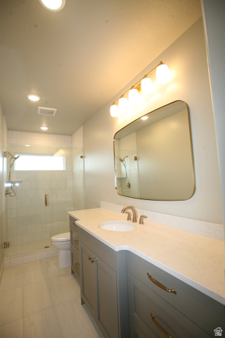 635 East Mountain Road North Ogden, UT 84414 - Photo 11 of 33 Contemporary bathroom featuring a spacious vanity with an undermount sink and light-toned countertop, a frameless mirror, and a glass-enclosed shower with subway tile surround and a transom window