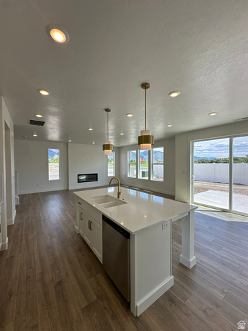 1225 West 500 South Logan, UT 84321 - Photo 12 of 39 Spacious open-concept living area featuring an expansive kitchen island with a double sink and stainless steel dishwasher