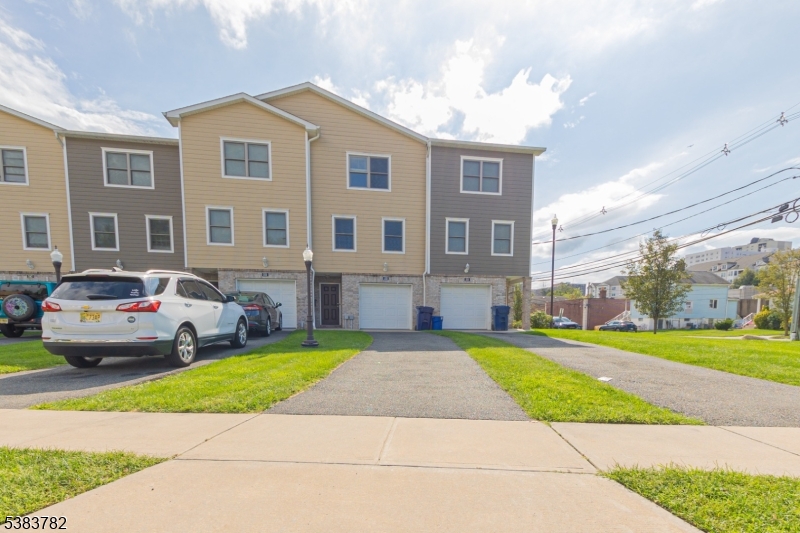 246 James Street Hackensack, NJ 07601 - Photo 21 of 23 a front view of a house with a yard and garage